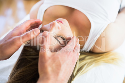 Relaxed pregnant woman enjoying reiki technique