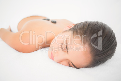 Beautiful brunette enjoying a hot stone massage