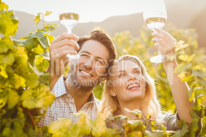 Young happy couple holding glasses of wine
