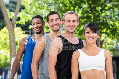 Portrait of smiling extreme athletes standing in a row