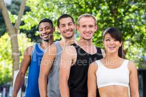 Portrait of smiling extreme athletes standing in a row