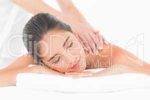 Attractive woman receiving shoulder massage at spa center