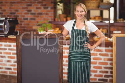 Pretty waitress holding a big chalkboard