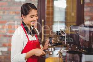 Pretty barista making a cup of coffee