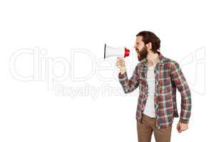 Handsome hipster shouting through megaphone