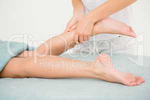 Masseur massaging womans leg