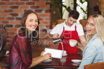 Handsome waiter preparing a cup of coffee