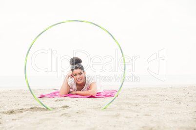 Smiling woman looking at camera through hula hoop Smiling woman looking at camera through hula hoop