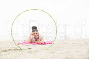 Smiling woman looking at camera through hula hoop