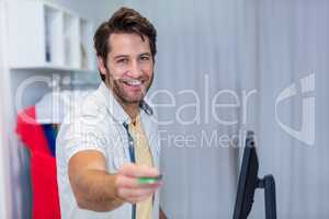 Smiling cashier handing back credit card