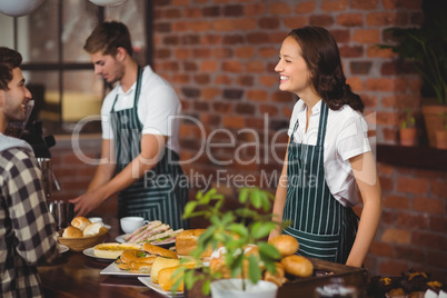 Pretty waitress talking with a customer