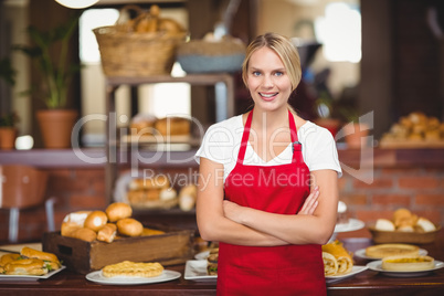 Pretty waitress with arms crossed