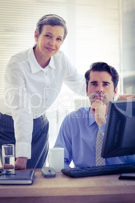 Portrait of two colleagues working together on computer