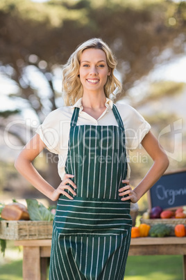 Smiling farmer woman with hands on hips