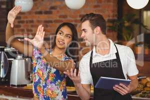 Pretty customer explaining to waiter