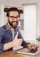 Hipster businessman showing thumbs up to camera