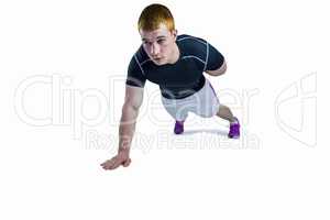Muscular rugby player doing one hand push ups
