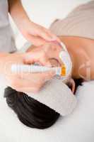 Attractive woman receiving treatment at spa center