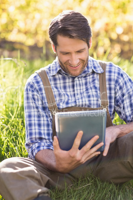 Smiling farmer using a digital tablet