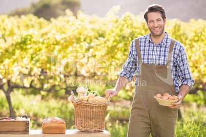 Farmer holding a basket of potatoes and eggs