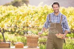Farmer holding a basket of potatoes and eggs