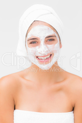 Smiling woman having white cream on her face Smiling woman having white cream on her face