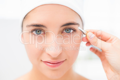 Hand applying eyeshadow to beautiful woman