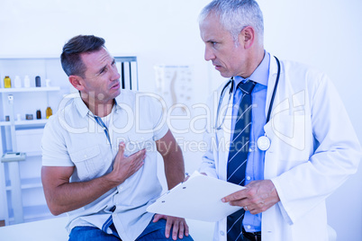 Serious doctor speaking with his patient