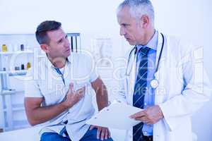 Serious doctor speaking with his patient