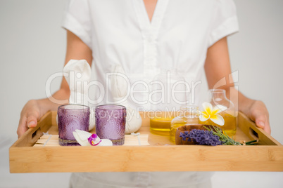 Woman holding a tray with glasses and flowers