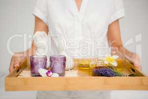 Woman holding a tray with glasses and flowers