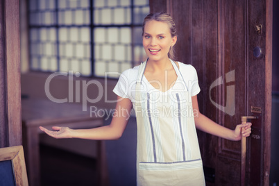 Smiling blonde waitress welcoming