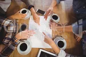 Friends discussing and drinking coffee