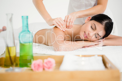 Pretty brunette enjoying a massage