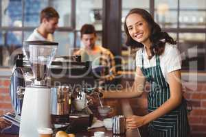 Pretty barista making a cup of coffee