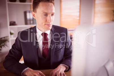 Stylish businessman working at his desk