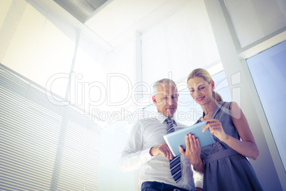 Business people discussing over a digital tablet