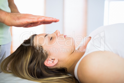 Close up view of pregnant woman getting reiki treatment