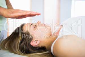 Close up view of pregnant woman getting reiki treatment