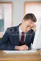 Worried businessman working at his desk