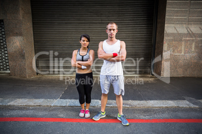Portrait of extreme athletes standing with arms crossed
