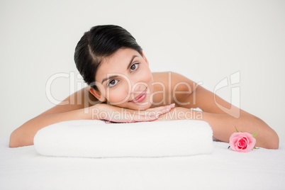 Pretty brunette enjoying a massage smiling at camera