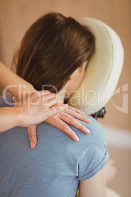 Young woman getting massage in chair