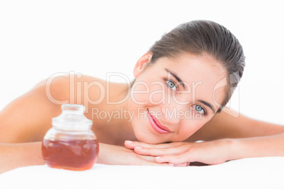 A portrait smiling pretty brunette on massage table