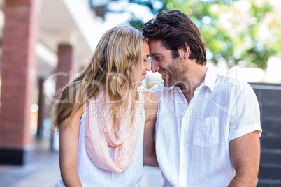 Smiling couple sitting with joined head