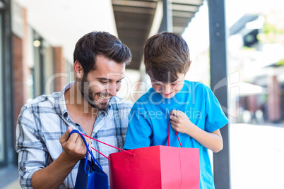 A father and his son looking into the bag