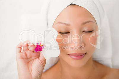 Attractive young woman holding a flower