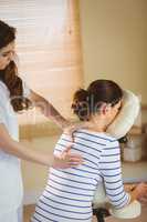 Young woman getting massage in chair