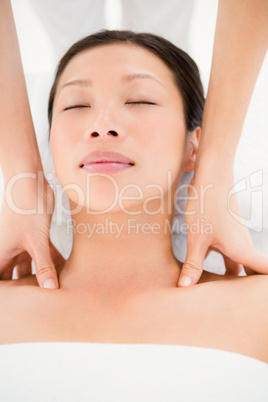 Attractive young woman receiving shoulder massage