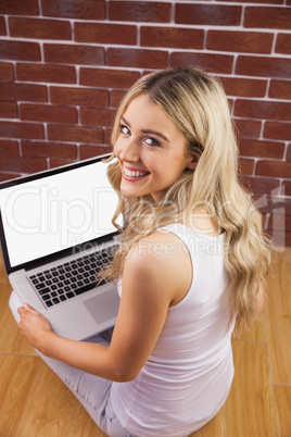 Portrait of a beautiful woman with laptop on her knee